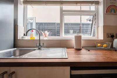 a kitchen counter with a sink and a window at SuffStay in Ipswich