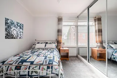a bedroom with a bed and a window at SuffStay in Ipswich