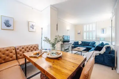 a living room with a table and a couch at Seaway Cottage, Aldeburgh in Aldeburgh