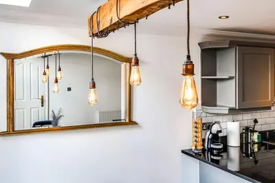 a mirror in a kitchen with pendant lights at Entire 3 Bedroom House Contractors Families Relocators in Ware