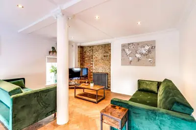 a living room with a couch and a table at Entire 3 Bedroom House Contractors Families Relocators in Ware
