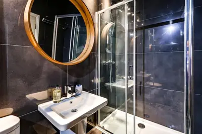 a bathroom with a sink and a shower with a mirror at Entire 3 Bedroom House Contractors Families Relocators in Ware