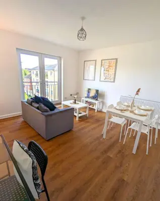 a living room with a couch and a table at 3-Bed, Sleeps 6, 1 Bath, Parking, WiFi in Ipswich