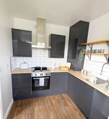 a kitchen with a sink and a stove top oven at 3-Bed, Sleeps 6, 1 Bath, Parking, WiFi in Ipswich