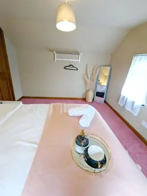 a room with a bed with a plate on it at 3-Bed, Sleeps 6, 1 Bath, Parking, WiFi in Shalford