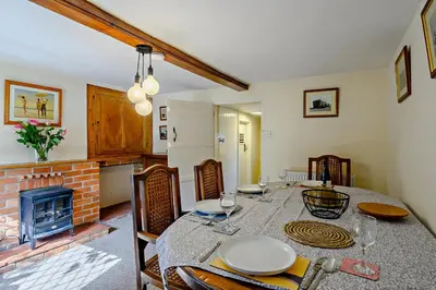 a dining room with a table and a fireplace at 2 Bed in Dennington oc-b28010 in Dennington
