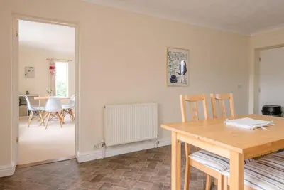 a kitchen with a table and chairs and a dining room at Grove Farm Bungalow and Annexe, Dallinghoo in Woodbridge