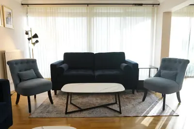 a living room with a couch and two chairs at Lady Jane Court in Trumpington