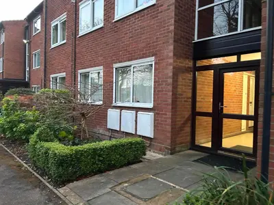 a brick building with a door in front of it at Lady Jane Court in Trumpington