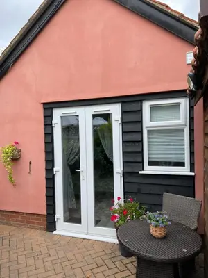 a patio door with a table in front of a house at Kings head Inn in Stutton