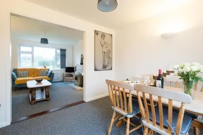 a living room with a table and a couch at Hollybobs in Leiston