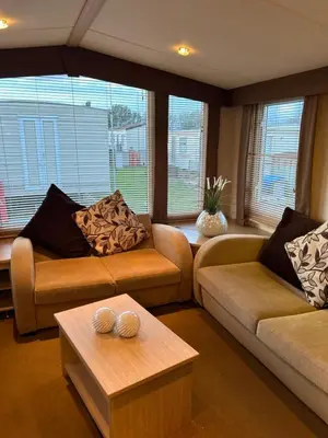 a living room with two couches and a coffee table at Havah’s in Saint Osyth
