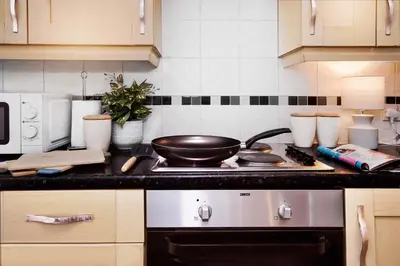 a kitchen with a stove with a frying pan on it at Entire House in Ipswich - Handford in Ipswich