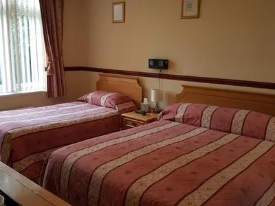 a hotel room with two beds and a window at Nyton Hotel in Ely