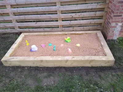 a sandbox with childrens toys in the sand at The Walled Garden in Long Melford