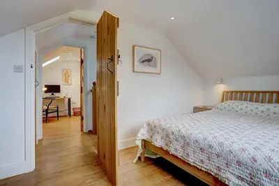 a bedroom with a bed and a desk at Contemporary Barn Harleston Norfolk in Harleston