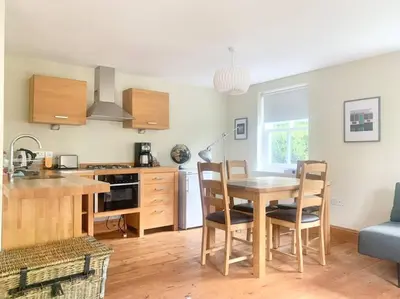 a kitchen and dining room with a table and chairs at Delightful Ely house Bright and warm with cathedral view in Ely