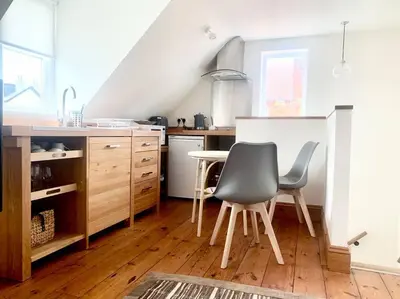 a kitchen with a table and chairs in a room at Delightful Ely house Bright and warm with cathedral view in Ely