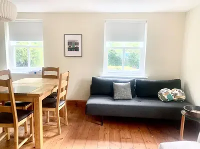 a living room with a couch and a table at Delightful Ely house Bright and warm with cathedral view in Ely