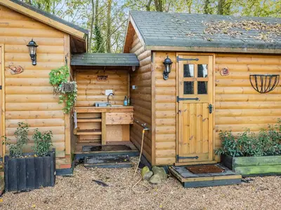 a wooden cabin with a sink and a door at Bear House- Uk45704 in Brinkley