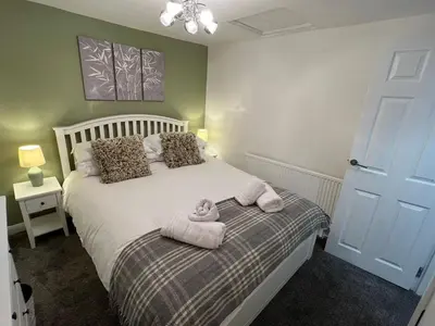 a bedroom with a bed with a teddy bear on it at Central Brentwood House in Brentwood
