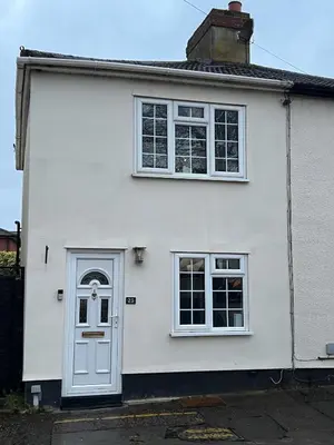 a white house with a door and two windows at Central Brentwood House in Brentwood