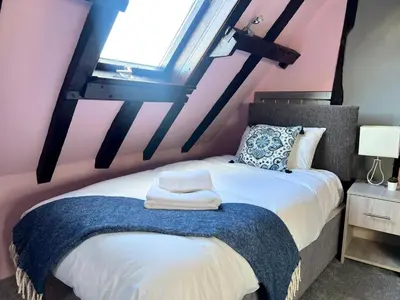 a bedroom with a bed and a window at Duchess Apt 2 Modern 3Bedroom Apartment in Colchester Ideal for Long Stays, Relocations, Contractors, Secure Parking, WIFI in Colchester