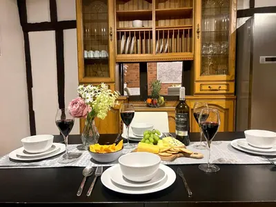 a table with glasses of wine and bowls of fruit at Duchess Apt 2 Modern 3Bedroom Apartment in Colchester Ideal for Long Stays, Relocations, Contractors, Secure Parking, WIFI in Colchester