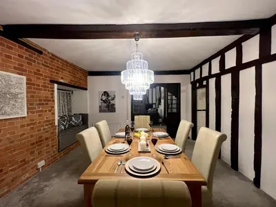 a dining room with a wooden table and a chandelier at Duchess Apt 2 Modern 3Bedroom Apartment in Colchester Ideal for Long Stays, Relocations, Contractors, Secure Parking, WIFI in Colchester