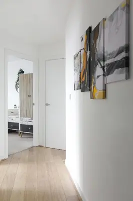 a hallway with paintings on the walls of a room at Jade Apartments Basildon in Basildon