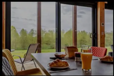 a table with food and a glass of orange juice at Meadow Valley Lodge 2 in Hintlesham
