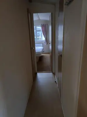 a hallway leading to a bathroom with a window at Dovercourt holiday park swift johnson low road harwich essex co12 3TZ in Parkeston