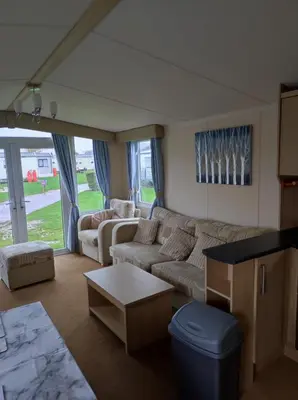a living room with a couch and a table at Dovercourt holiday park swift johnson low road harwich essex co12 3TZ in Parkeston
