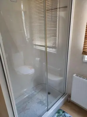 a glass shower with a toilet in a bathroom at Dovercourt holiday park swift johnson low road harwich essex co12 3TZ in Parkeston