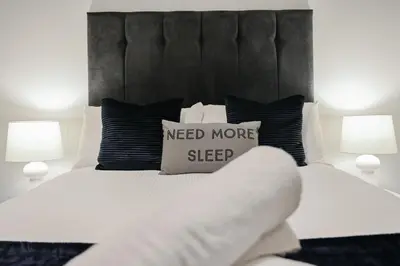 a bed with a need more sleep sign on it at Hurrell House in Boreham