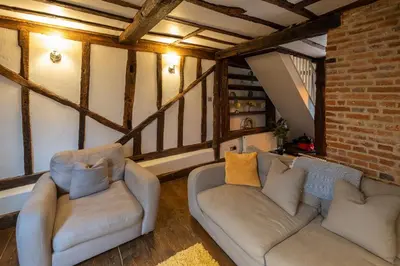 a living room with two couches and a brick wall at Charming 2 bedroom property in Bury Saint Edmunds