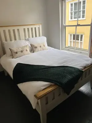 a bed in a room with a window at Charming 2 bedroom property in Bury Saint Edmunds