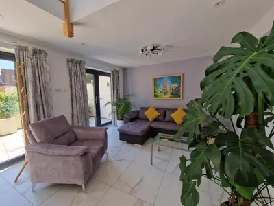 a living room with two couches and a plant at The Old Hay Store, Ely in Ely
