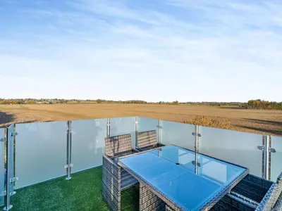 a glass house with a view of a field at Rose Cottage in Peldon