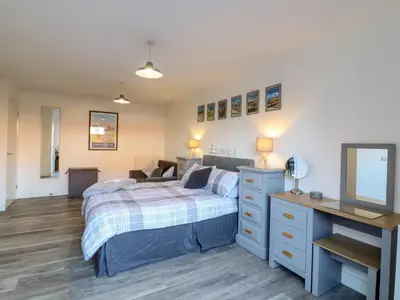 a bedroom with a bed and a desk at Little Haven in Frinton-on-Sea