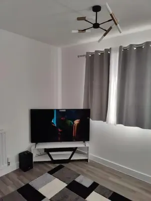a living room with a flat screen tv on a wall at 2 bedroom en-suite apartment in Basildon, Essex (Enjoy the simple things in life) in Laindon