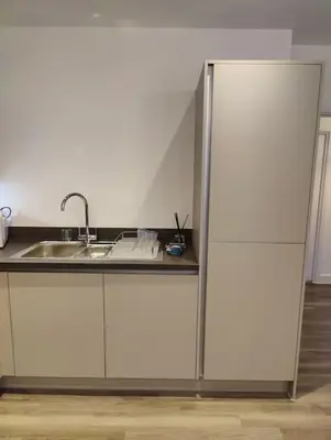 a kitchen with white cabinets and a sink at 2 bedroom en-suite apartment in Basildon, Essex (Enjoy the simple things in life) in Laindon