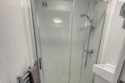 a shower with a glass door next to a sink at 1 Bed Sleeps 2 with Private Garden in Harlow
