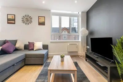 a living room with a couch and a tv at Chelmsford Centre View Sleep 4 Next Chelmer canal in Chelmsford