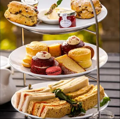 a three tiered display of different types of bread and pastries at Cosy Country Hideaway opposite Three Horseshoes Pub in Madingley village in Madingley