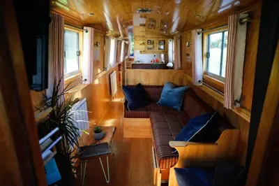 a view of a living room in a train car at Cambridge Narrowboats - Beautiful New Moon Narrowboat in Cambridge