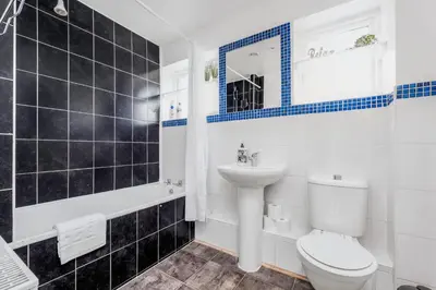 a bathroom with a toilet and a sink at 4 Bedroom House with Parking & Garden by Cherry Inn Short Let's & Services Accomodation in Cambridge
