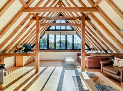a living room with wooden ceilings and a large window at 2 Bed in Diss oc-47778 in Hopton