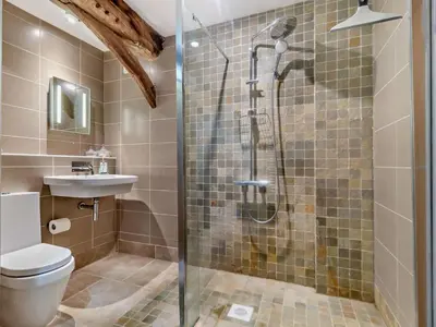 a bathroom with a shower with a toilet and a sink at 2 Bed in Diss oc-47778 in Hopton