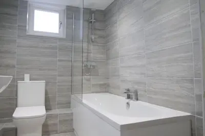 a bathroom with a tub and a toilet and a sink at The Butcher's Block in Puckeridge